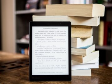 black tablet computer behind books