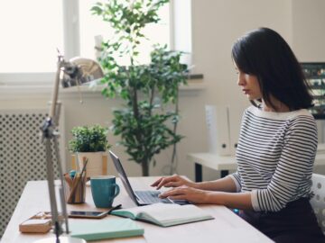 young woman using a laptop in an office