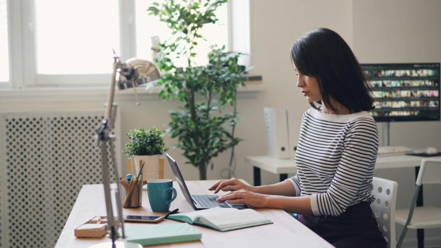 young woman using a laptop in an office