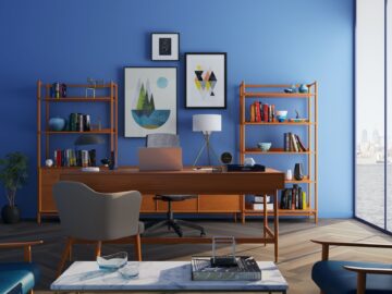 brown wooden desk with rolling chair and shelves near window