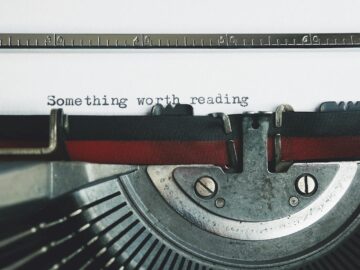 black and red typewriter on white table