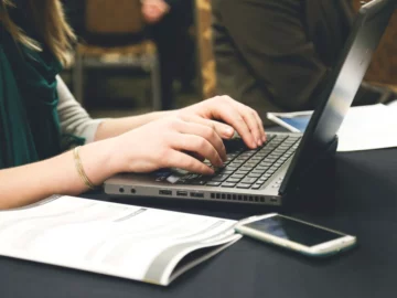 Free woman's hands typing laptop